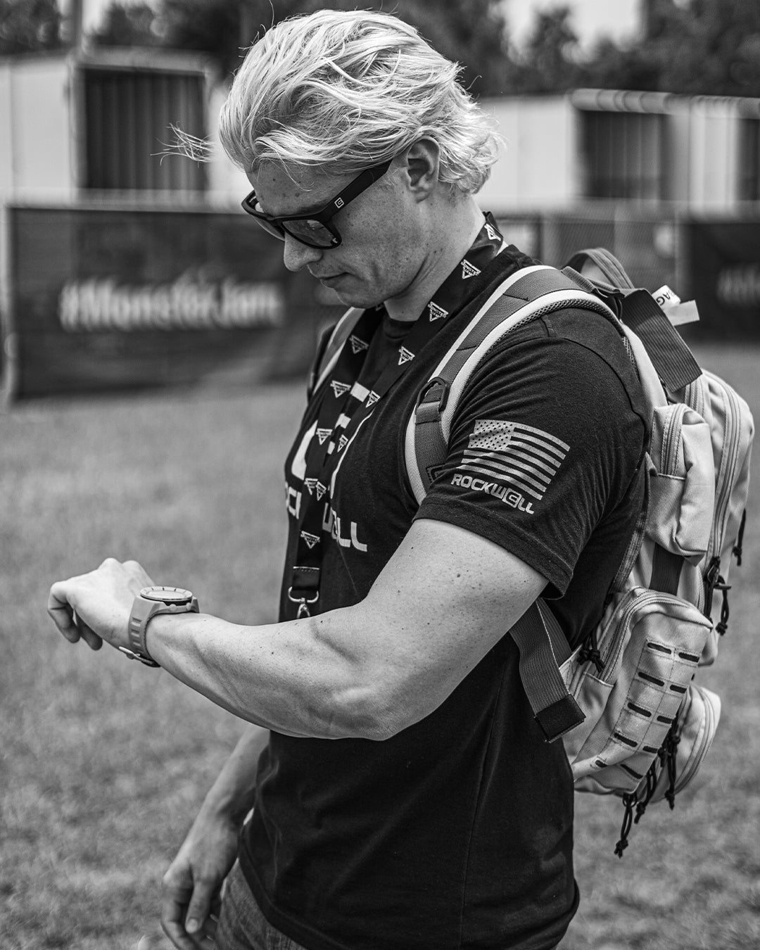 man looking at his coliseum watch while wearing the rockwell o g t shirt 